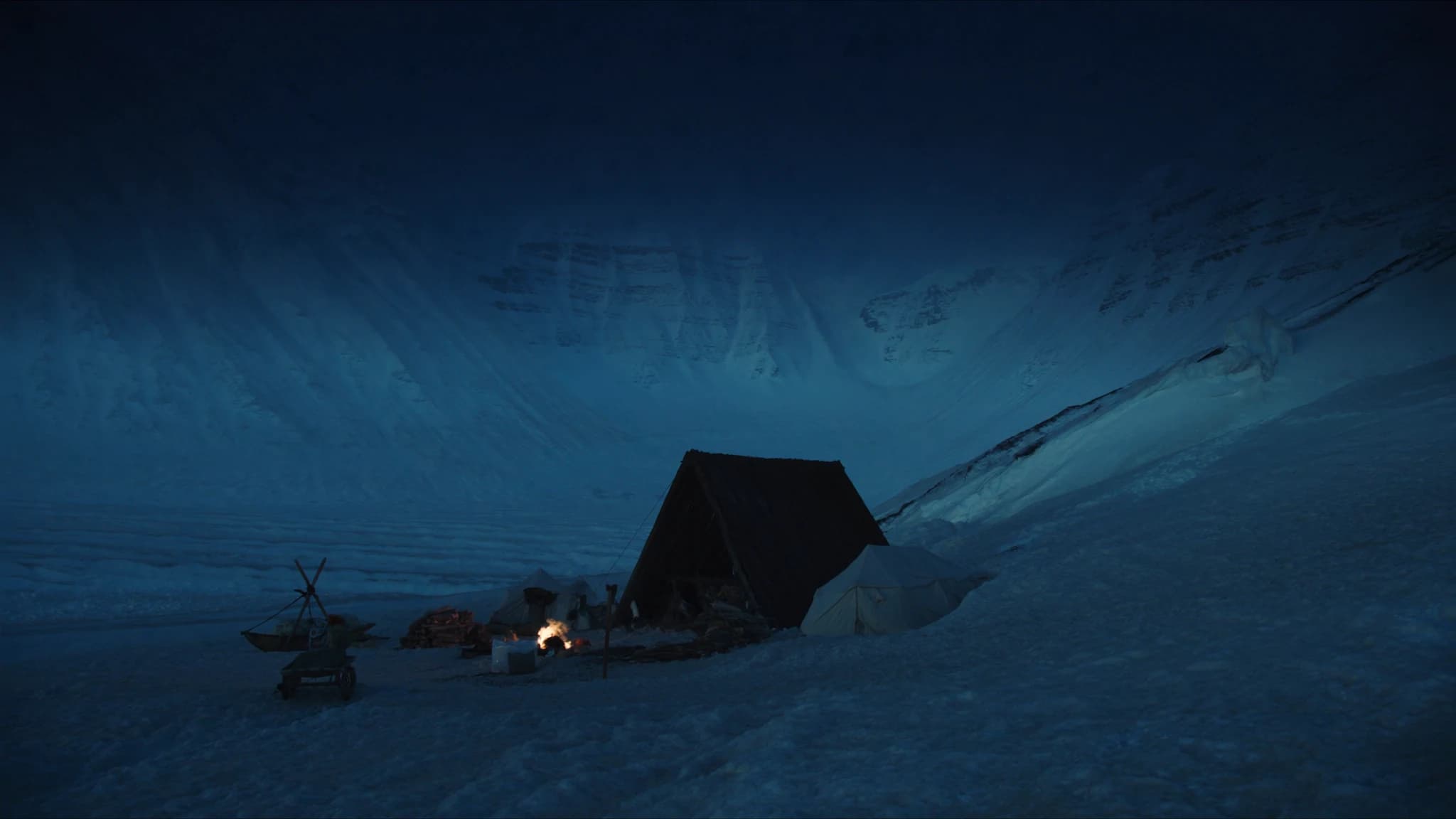 A winter survival camp beneath snow-covered mountains in Norway